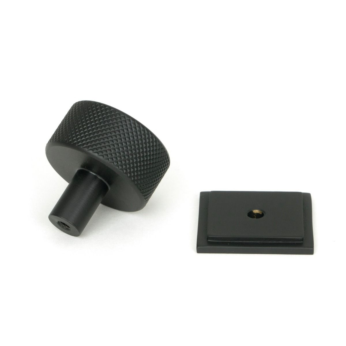 The 32mm Knurled Cabinet Knob on Square Rose in Matt Black Shown from Behind on a White Background
