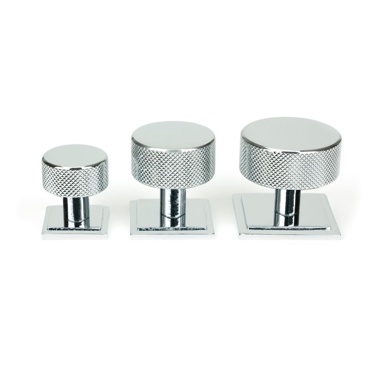 The 32mm Knurled Cabinet Knob on Square Rose in Polished Chrome Alongside Different Sizes on a White Background