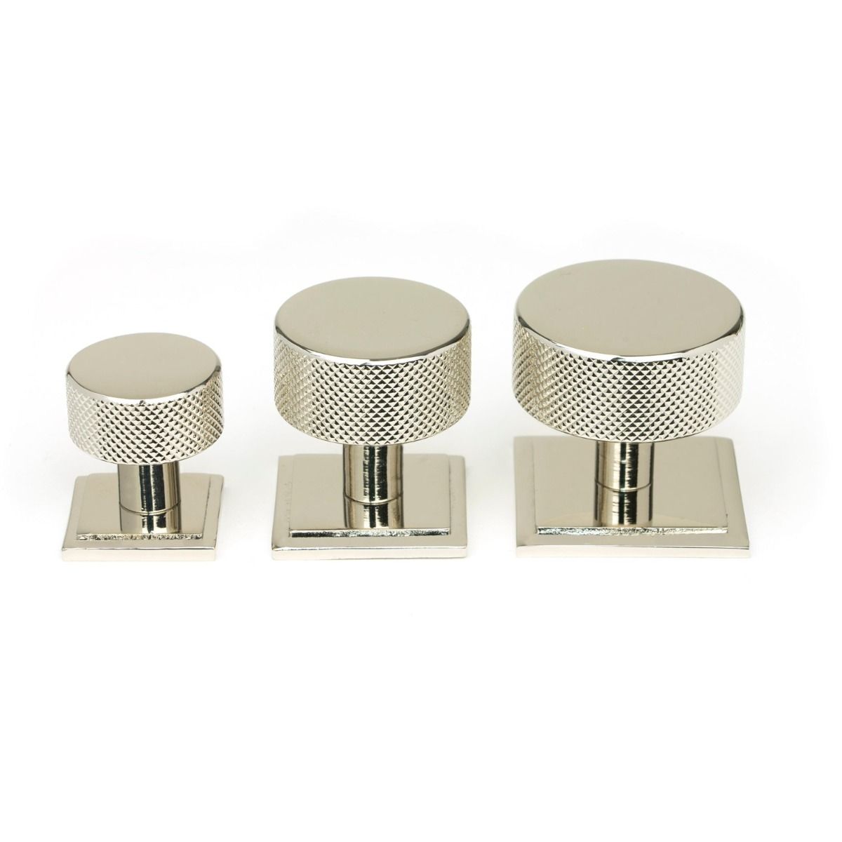 The 32mm Knurled Cabinet Knob on Square Rose in Polished Nickel Alongside Different Sizes on a White Background