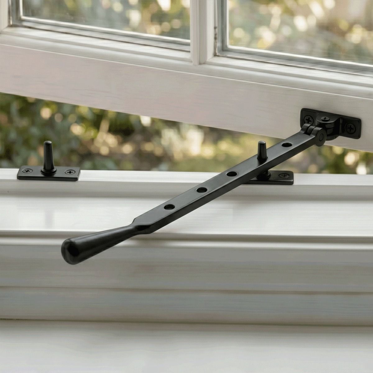The 335mm 12" Back Five Pin Window Stay in Black Fitted on an Opened Window in a Beautiful Home - Digital Illustration 