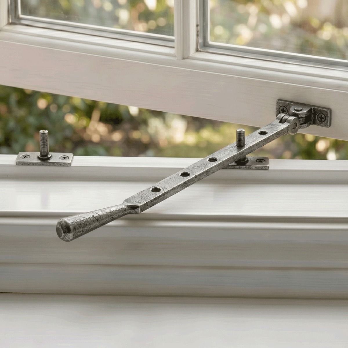 The 335mm 12" Pewter Five Pin Window Stay Fitted on a Classic White Window Frame - Digital Illustration