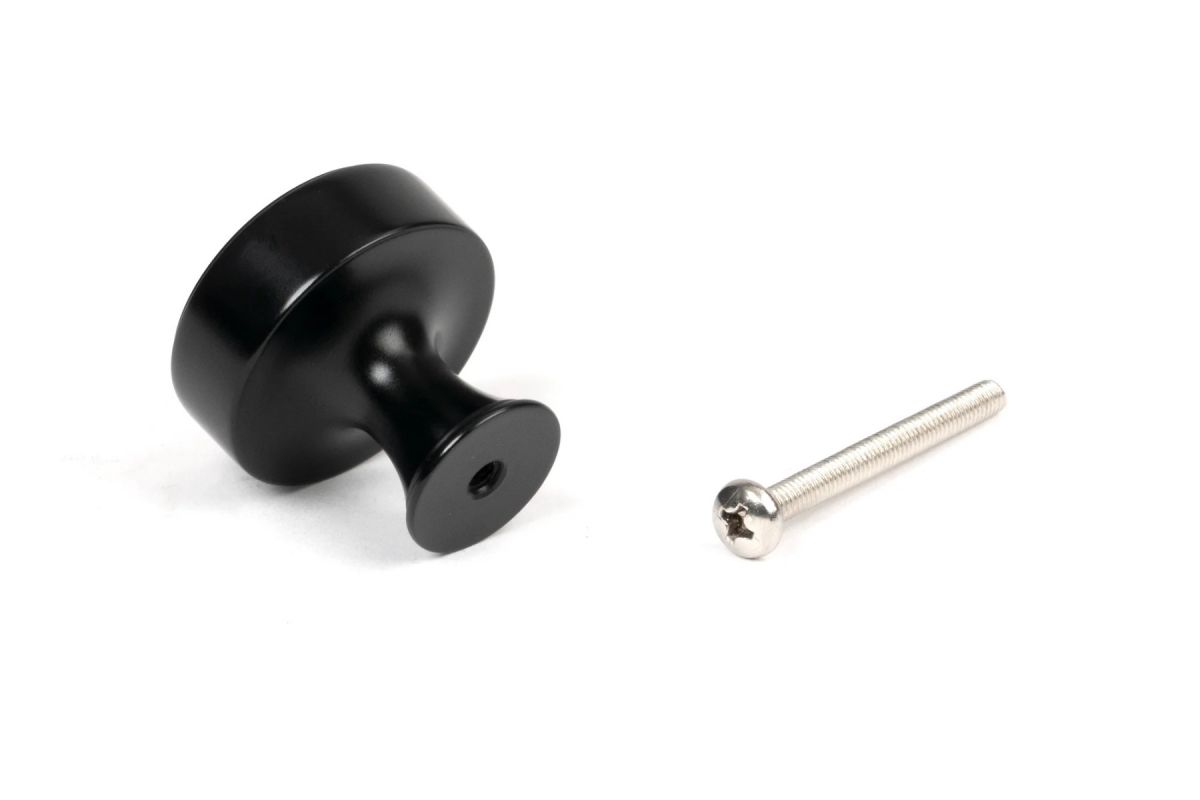 The 38mm "Atelier" Circular Cabinet Knob in Matt Black on a White Background Shown from behind with Screw 