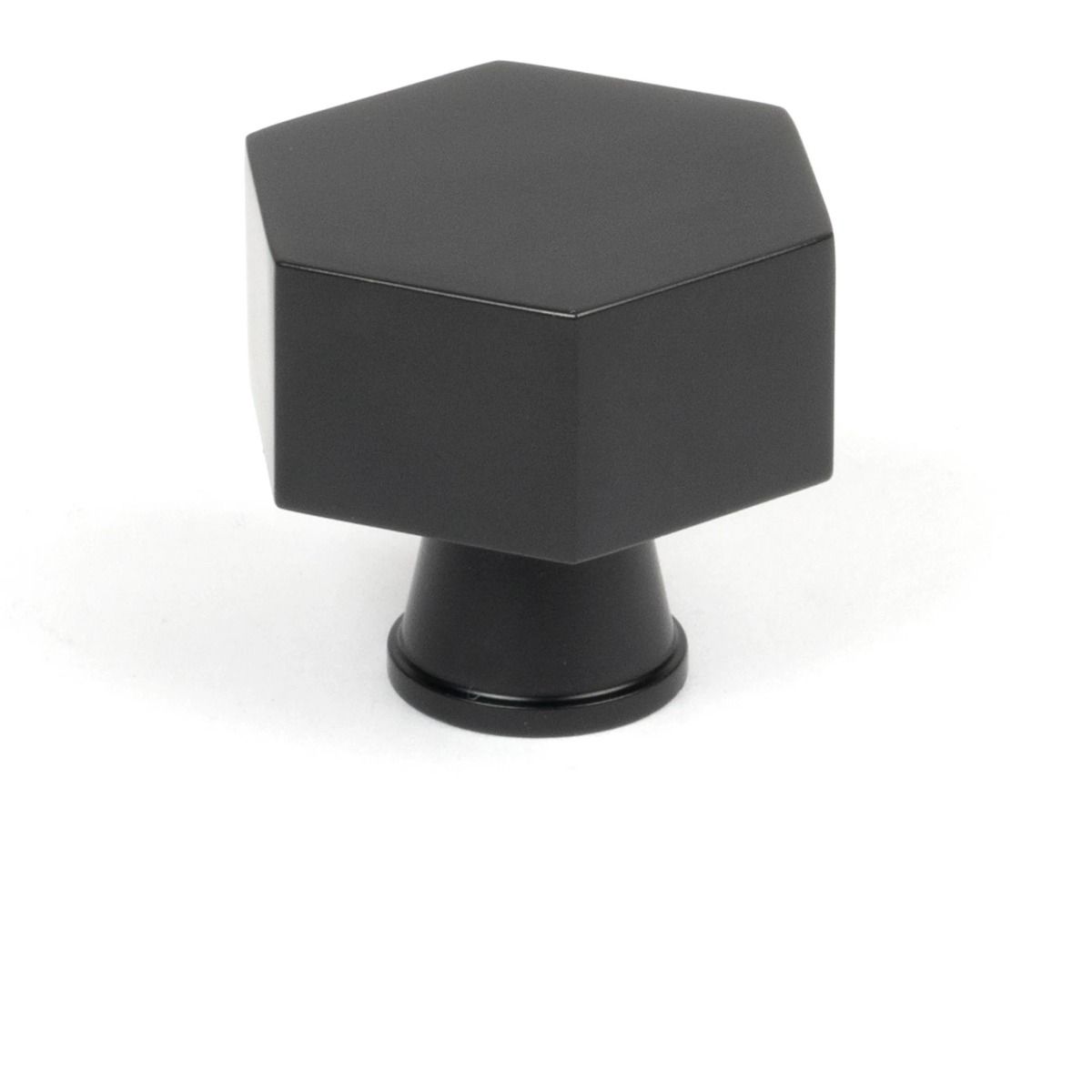 The 38mm "Vanguard" Hexagonal Cabinet Knob in Matt Black on a White Background Shown Stood Upright 