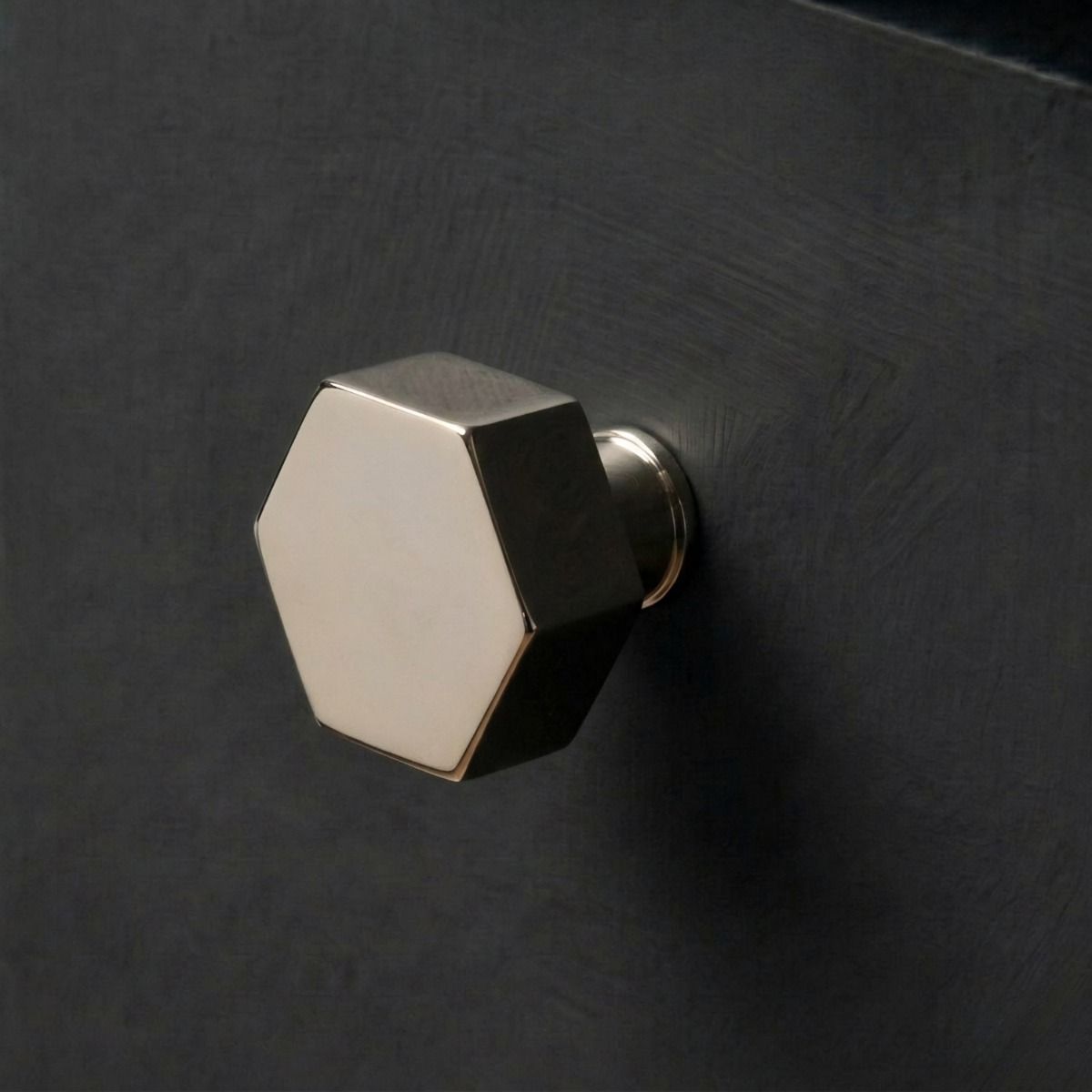 The 38mm "Vanguard" Hexagonal Cabinet Knob in Polished Nickel Mounted on a Charcoal Coloured Kitchen Drawer - Digital Illustration 