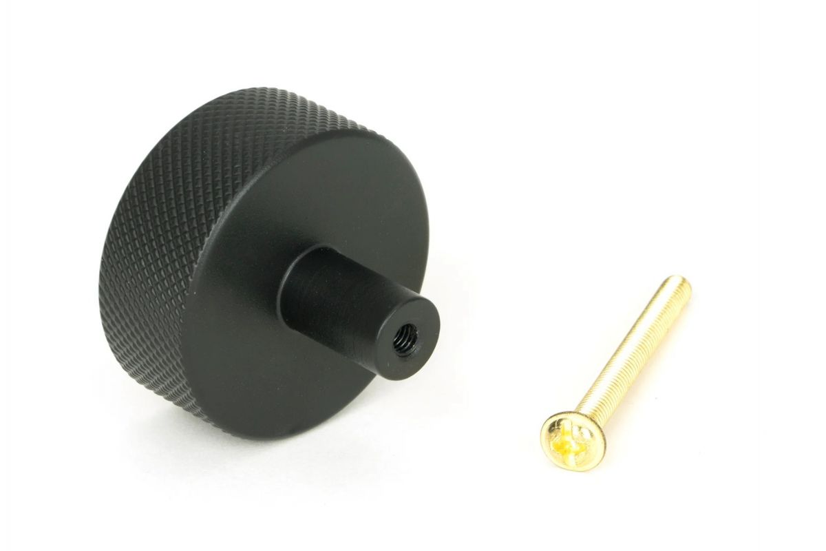 The 38mm "Vesper" Knurled Edge Cabinet Knob in Matt Black on a White Background Shown from Behind with the Screw