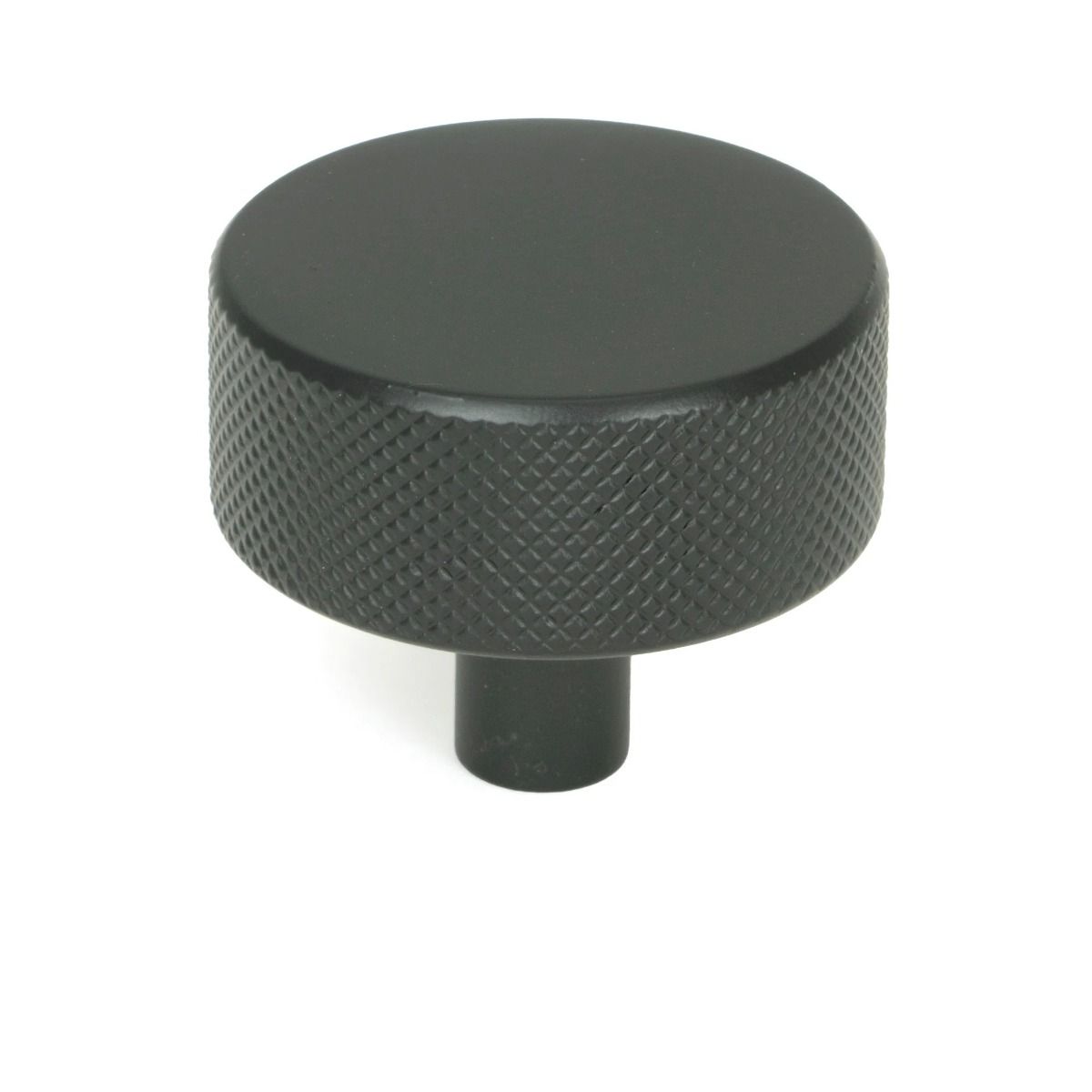 The 38mm "Vesper" Knurled Edge Cabinet Knob in Matt Black on a White Background Shown Stood Upright 