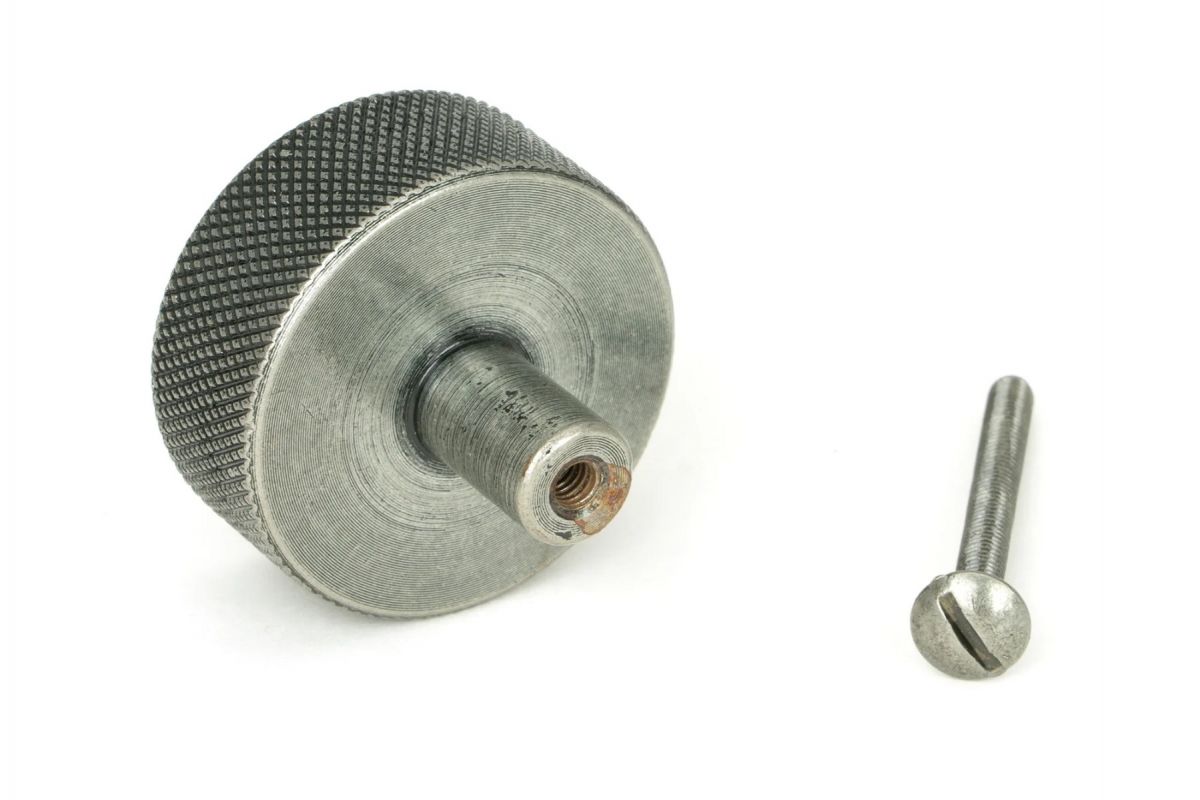 The 38mm "Vesper" Knurled Edge Cabinet Knob in Pewter Mounted on a White Background Shown ~From Behind with the Screw
