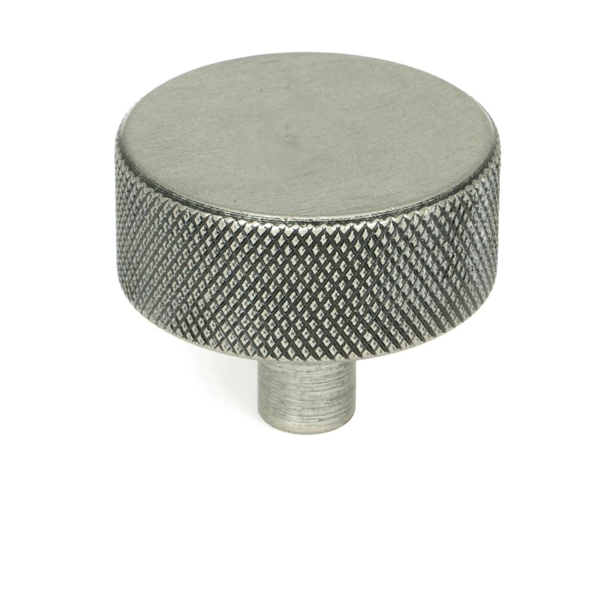 The 38mm "Vesper" Knurled Edge Cabinet Knob in Pewter Mounted on a White Background Stood Upright 