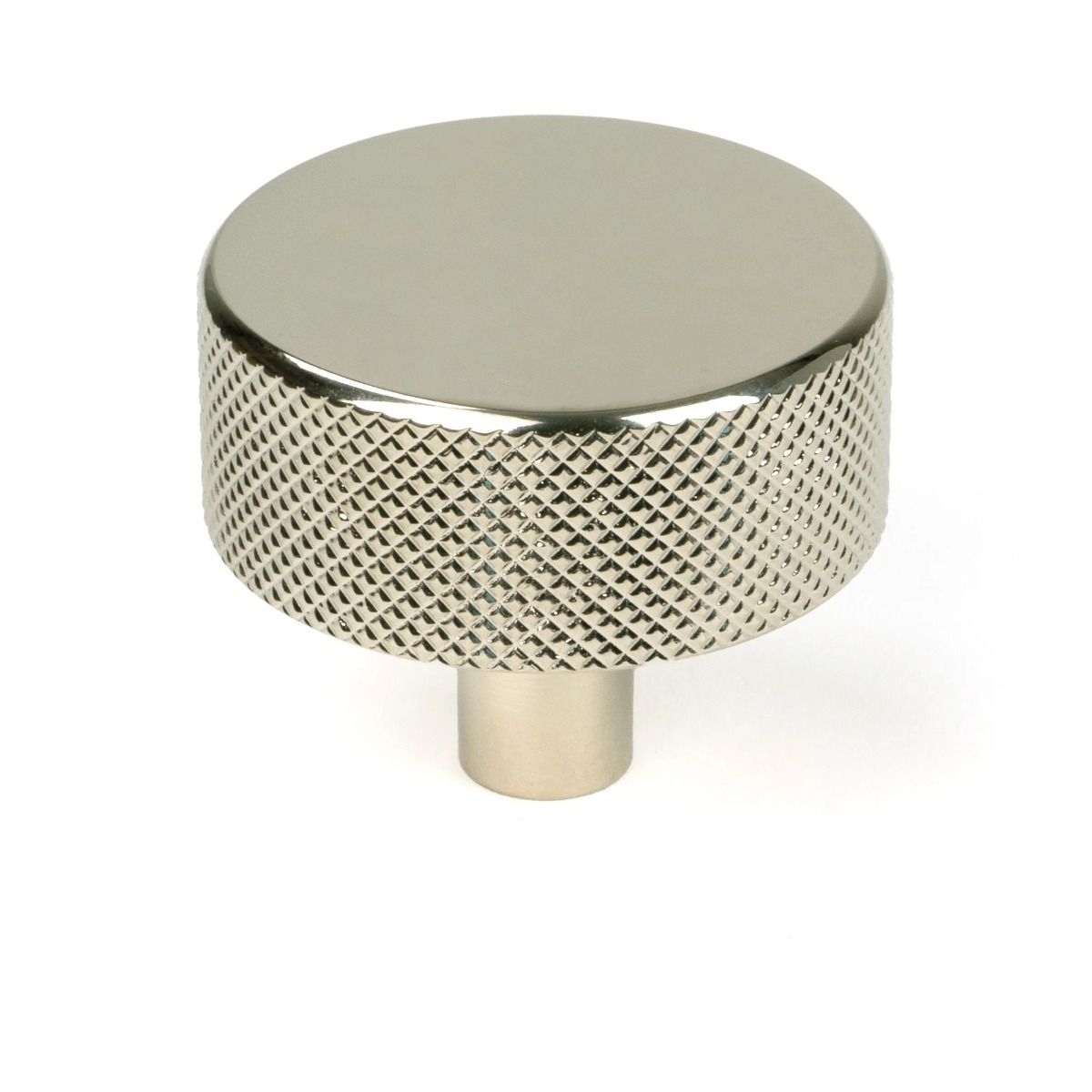 The 38mm "Vesper" Knurled Edge Cabinet Knob in Polished Nickel on a Plain White Background Stood Upright