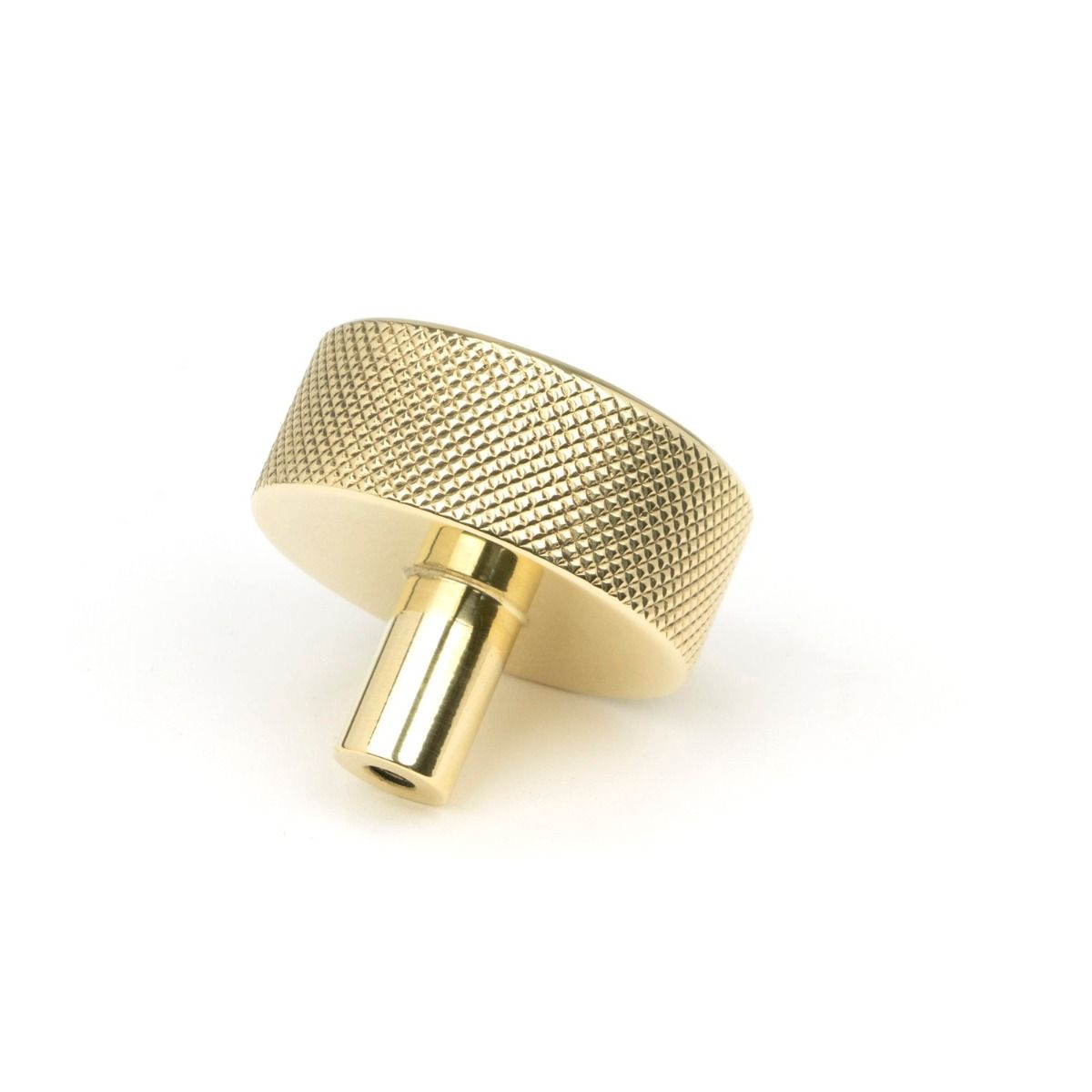 The 38mm Knurled Cabinet Knob (No Rose) in Polished Brass Shown on its Side on a White Background