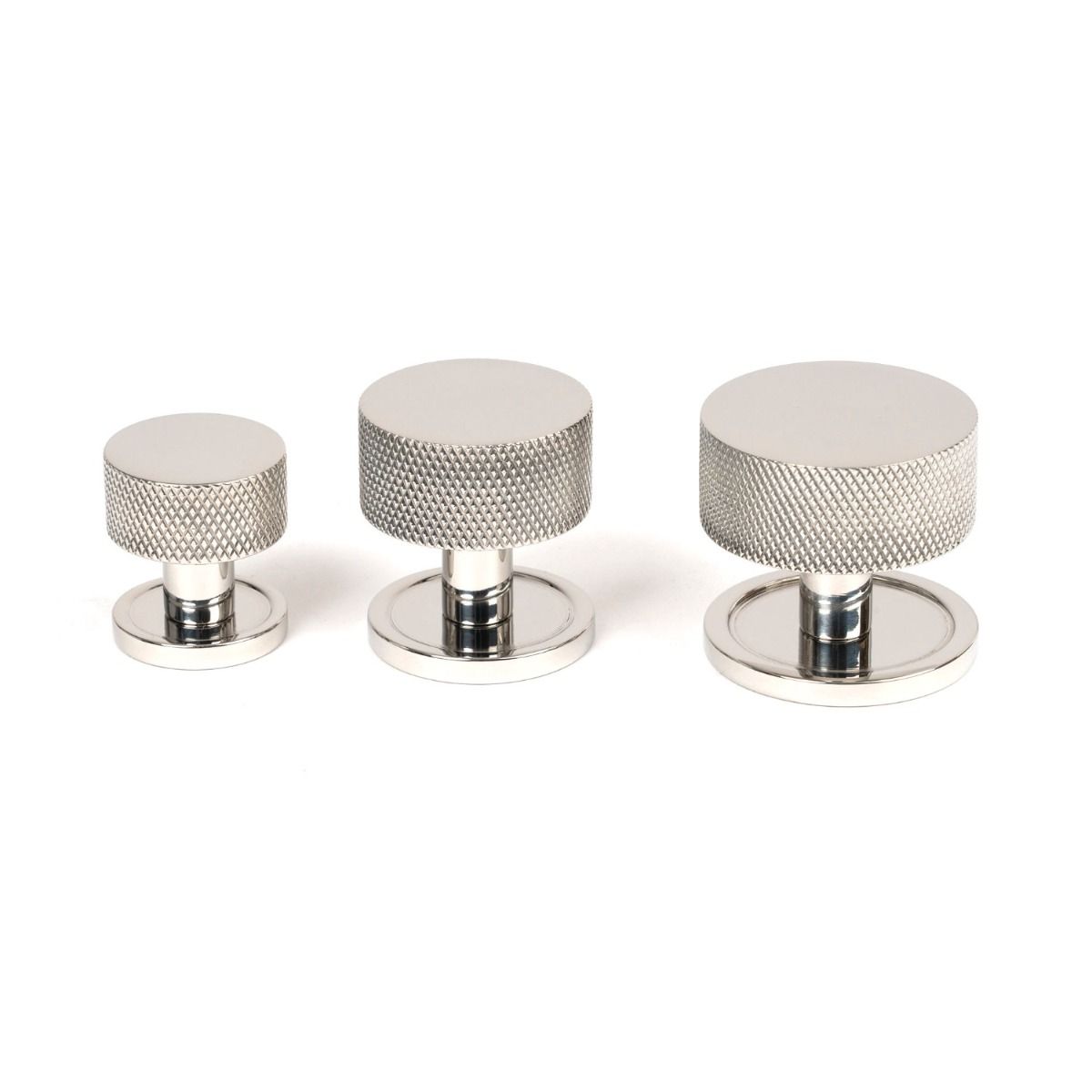 The 38mm Knurled Cabinet Knob on a Plain Rose in Polished Stainless Steel Next to Other Available Sizes on a White Background