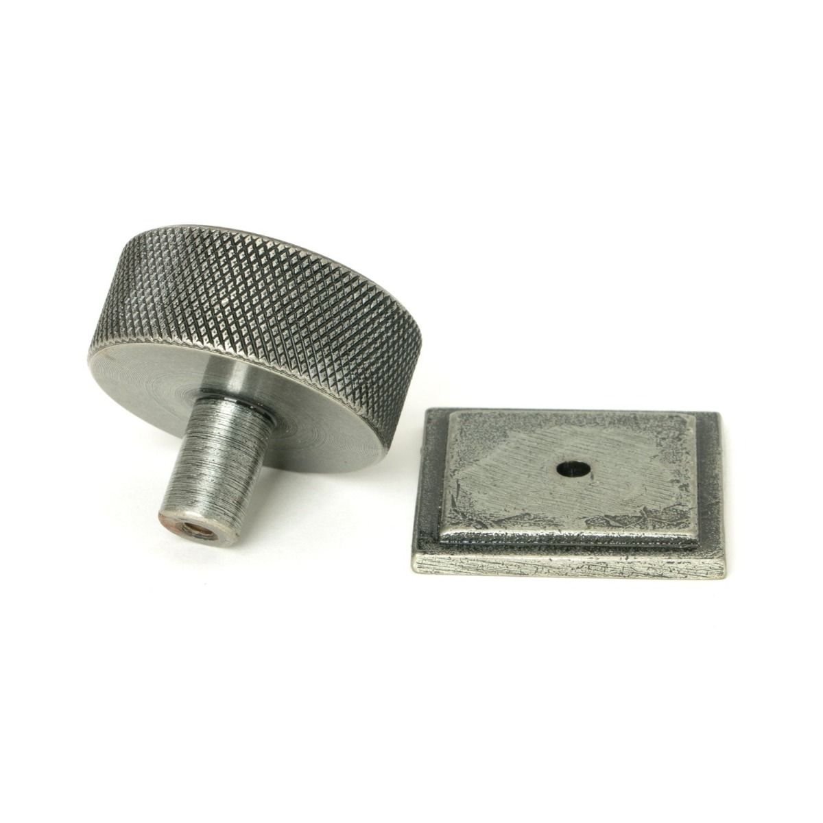 The 38mm Knurled Cabinet Knob on a Square Rose in Pewter Shown from Behind on a White Background
