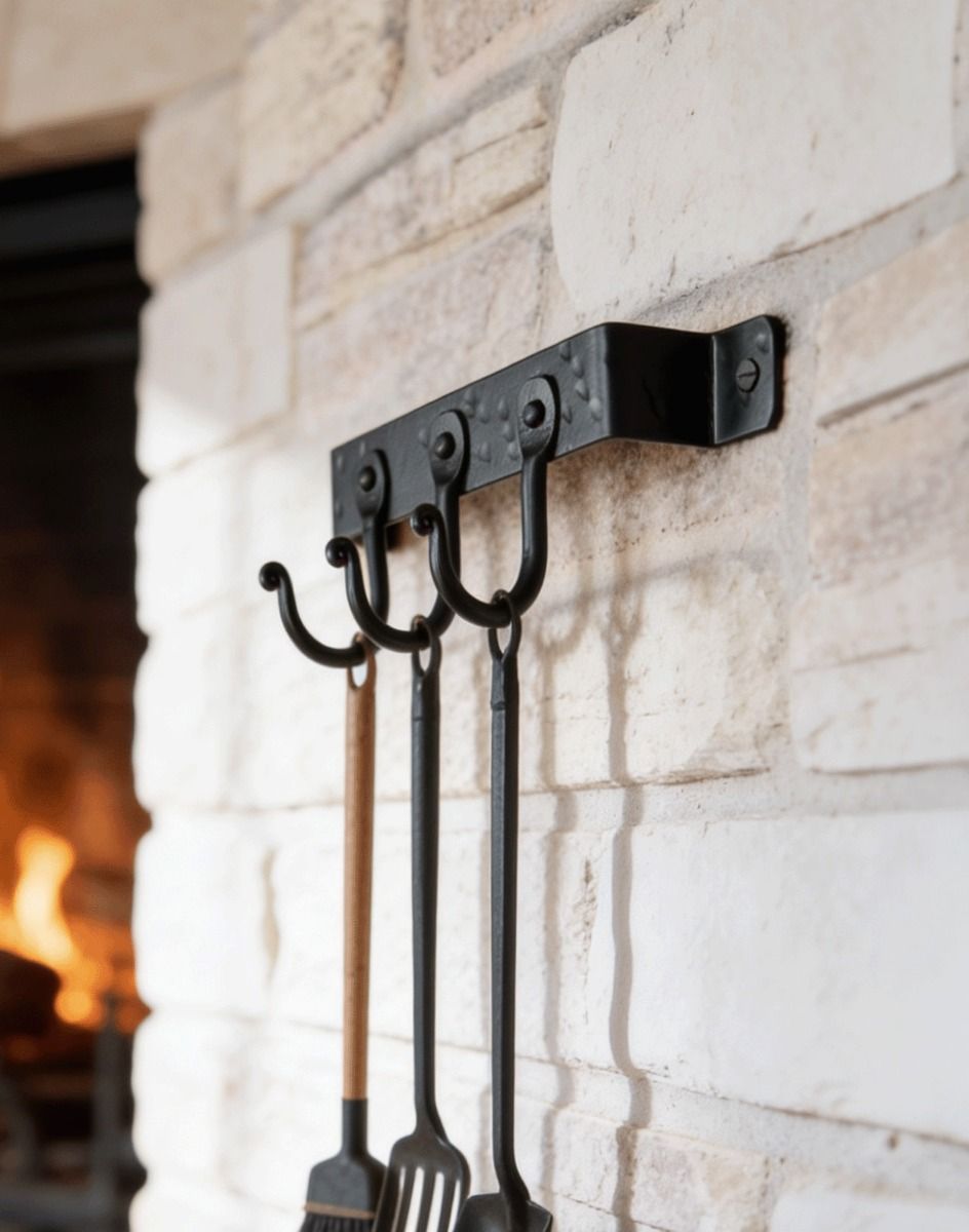 The 3 Hook "Blacksmith Style" Wall Mounted Fireside Tool Rack Mounted on a White Brick Wall with Tools Hanging From it - Digital Illustration 