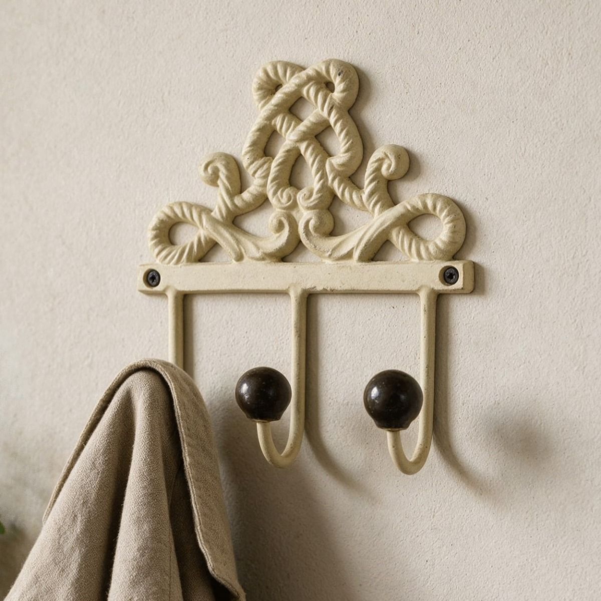 The 3 Hook scroll back plate Mounted on a Textured Wall with a Coat Hung on it - Digital Illustration 