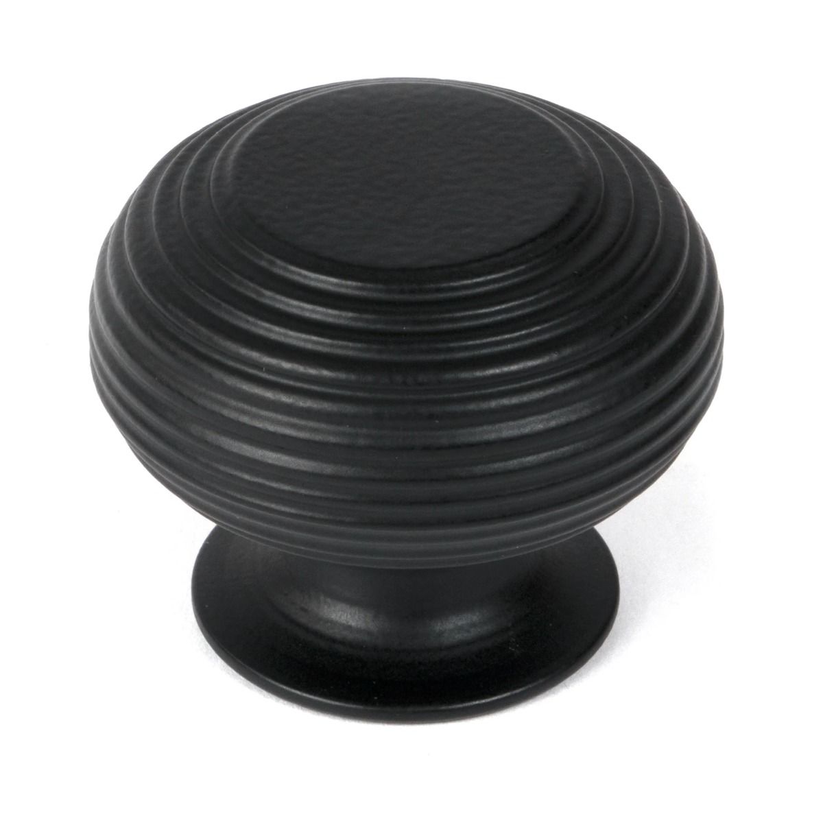 The 40mm "Garrison" Ribbed Beehive Knob in Matt Black on a White Background Shown Stood Upright 