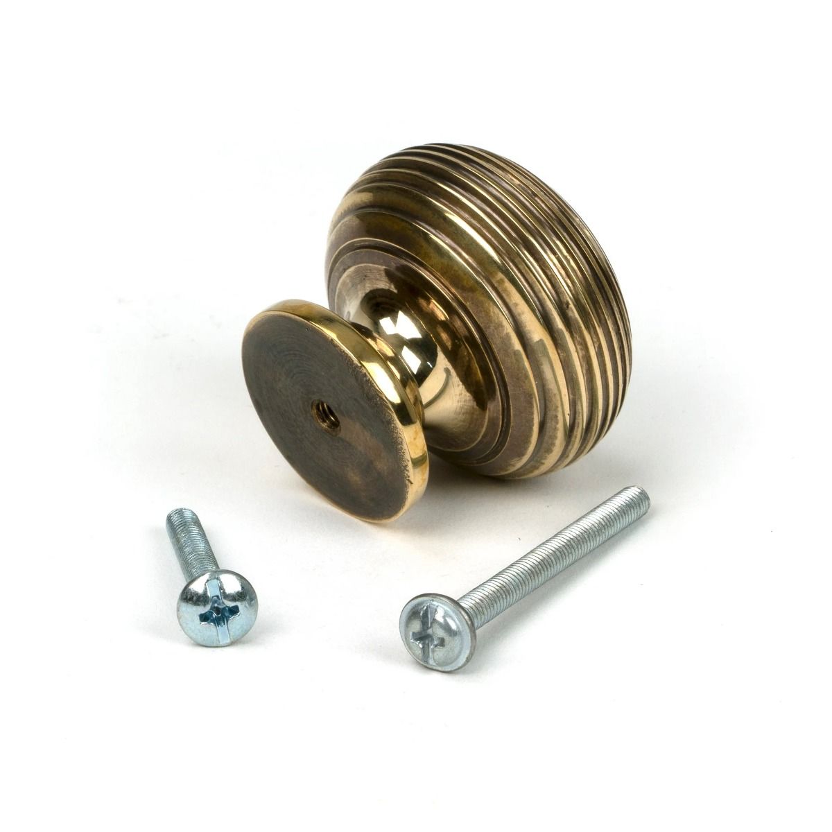 The 40mm Individual Aged Brass Beehive Cabinet Knob on a White Background Shown from Behind