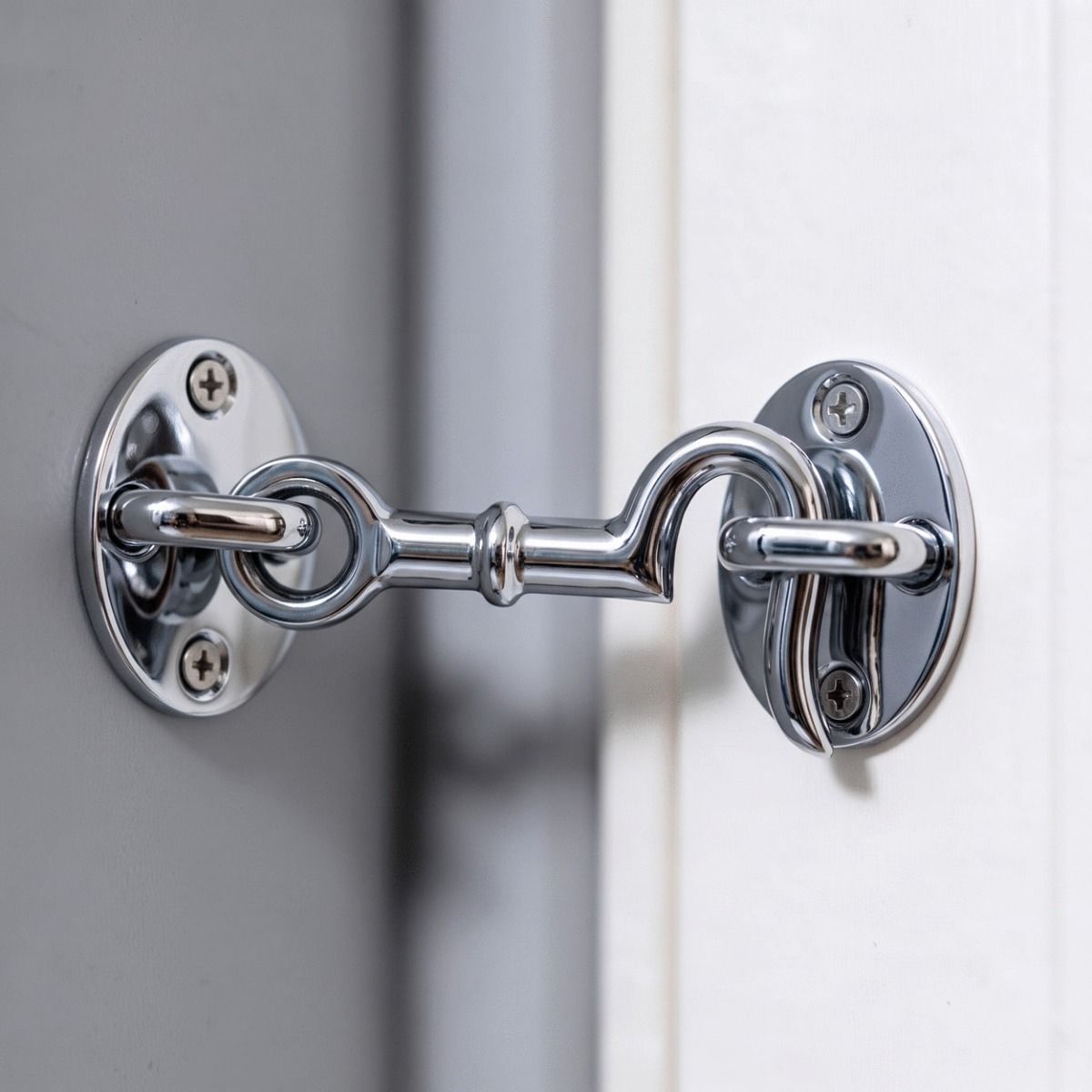 The 4 Inch Bright Chrome Cabin Hooks Loose Ring Type Shown Holding a Door Open in a Home - Digital Illustration