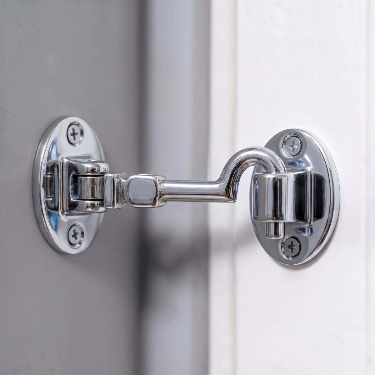 The 4 Inch Bright Chrome Cabin Hooks Silent Type Shown Holding Open a White Door - Digital Illustration 