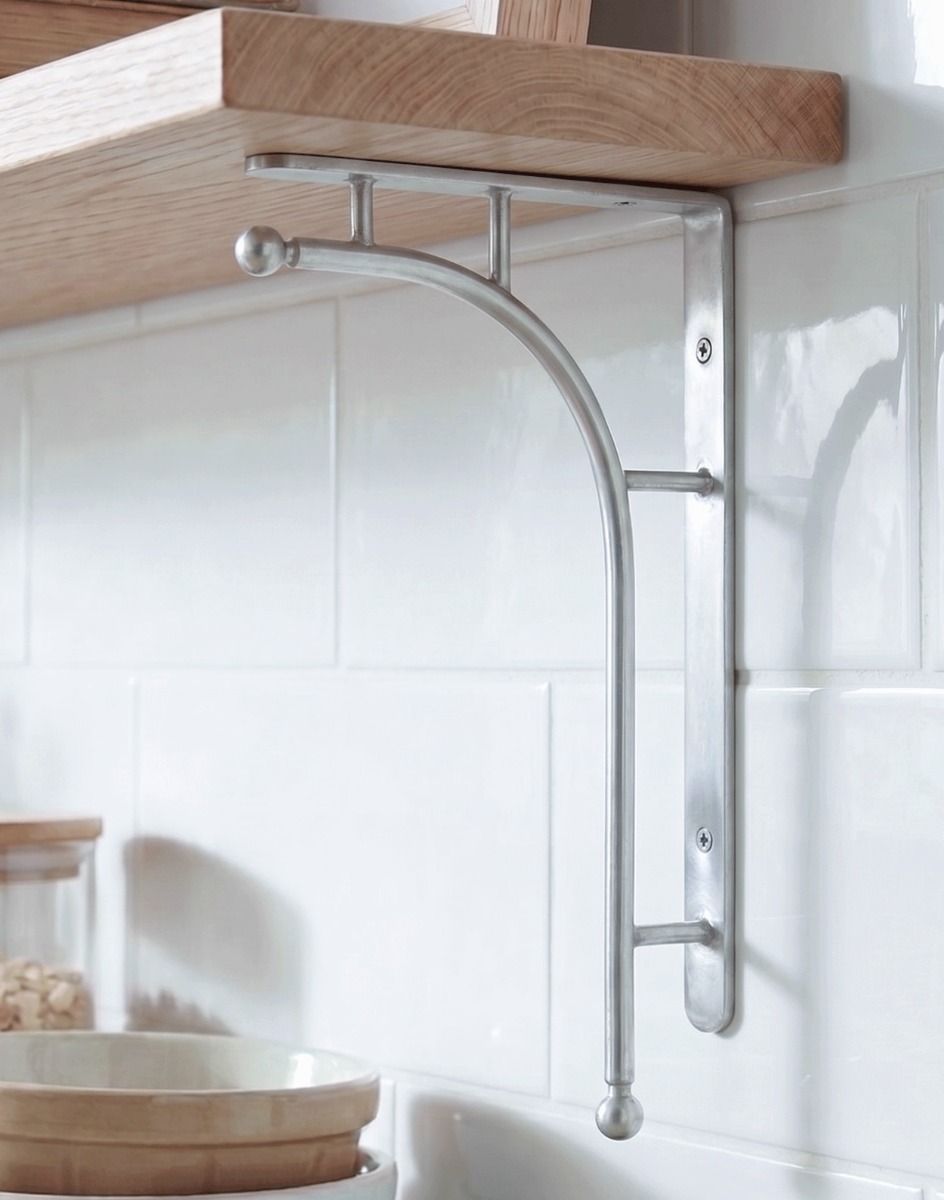 The 50 x 24cm ’Kepler’ Polished Aluminium Modern Wall Bracket Mounted on a White Tiled Kitchen Wall in a Modern Home - Digital Illustration 
