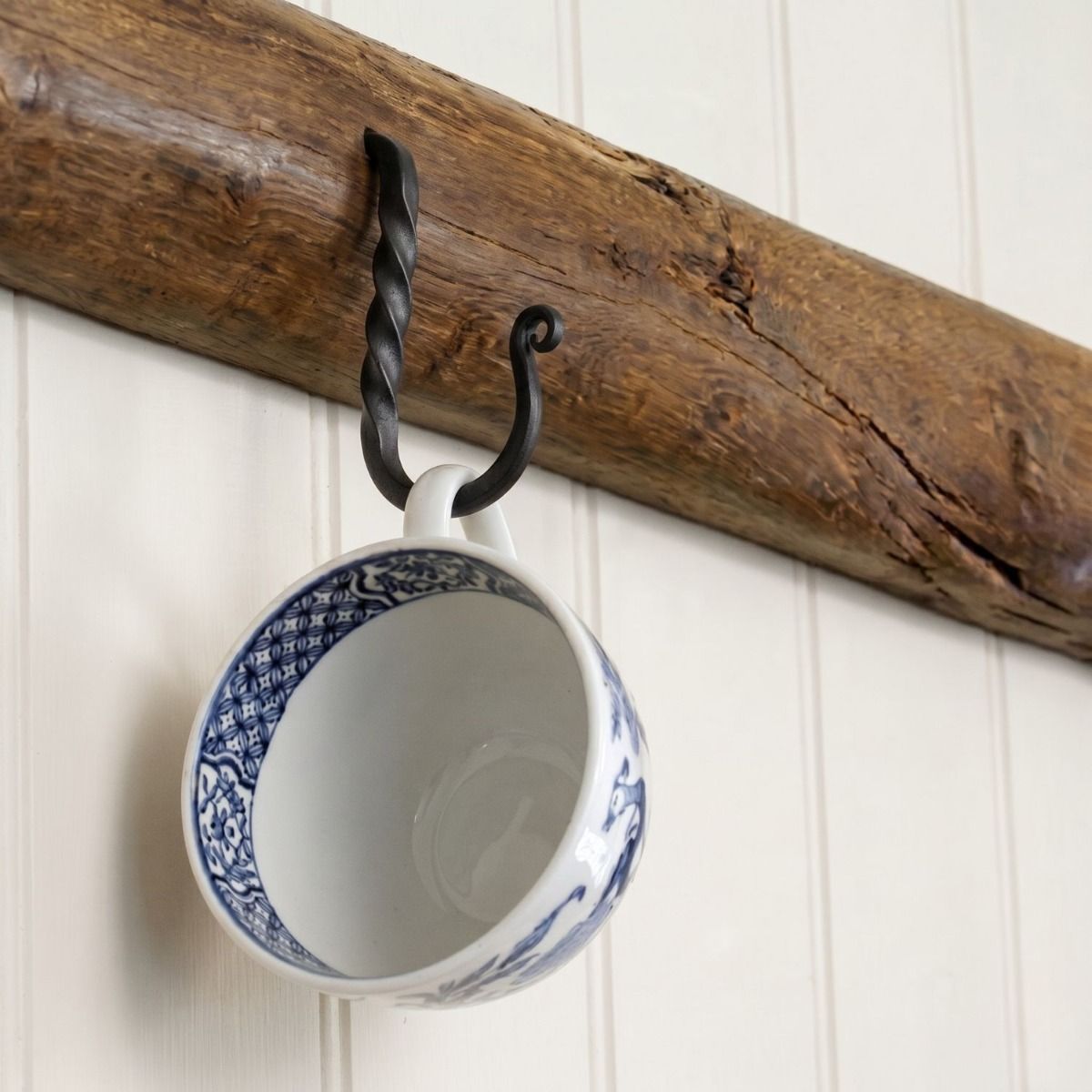 The 51mm Blacksmith Black Cup Hook Fitted on a Wooden Beam with a Tea cup hanging From it - Digital Illustration 