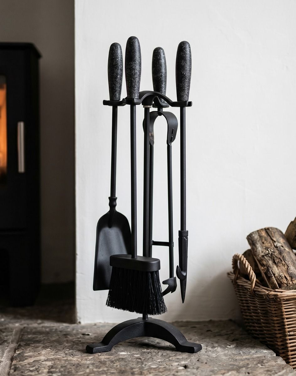 The 54m Matte Black & Gunmetal Effect Classical Four Tool Companion Set next to a Log Basket on a Fireplace - Digital Illustration 