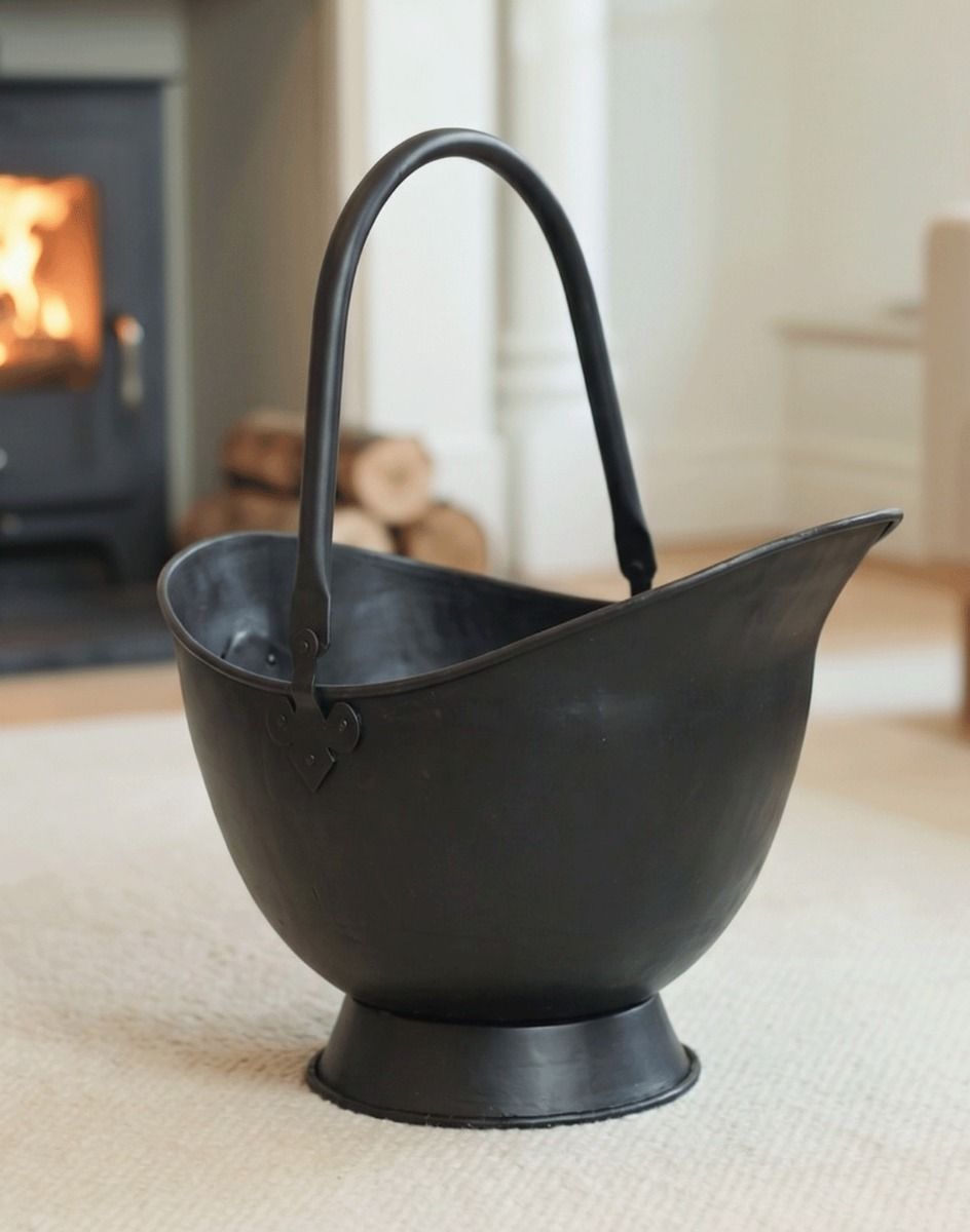 The 58cm "Waterloo" Black Iron Coal Bucket Displayed in a Modern Cream Living Room in Front of a Fireplace - Digital Illustration