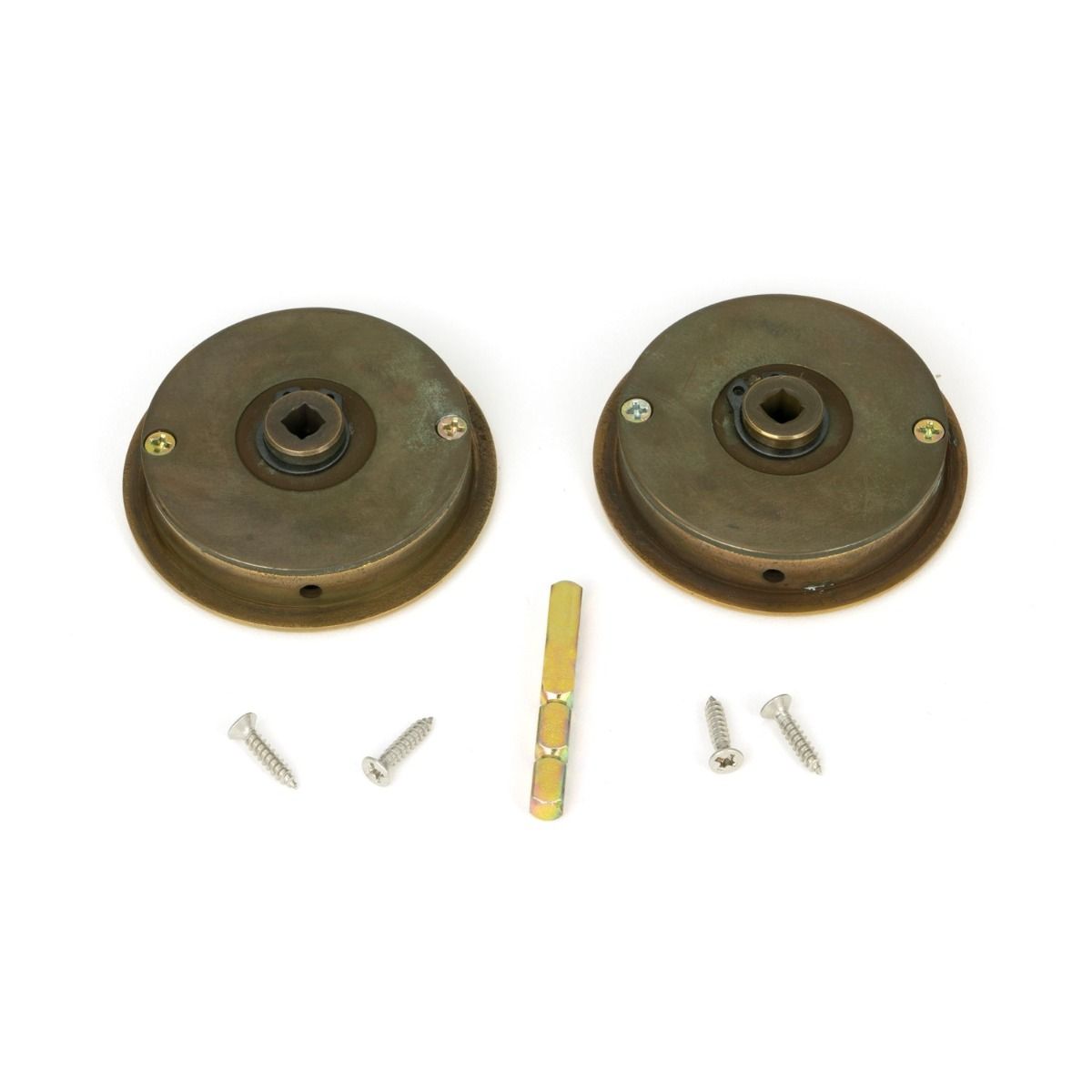 The 60mm Art Deco Round Sliding Pocket Door Privacy Set in Aged Brass Shown from Behind with Spindle and Screws
