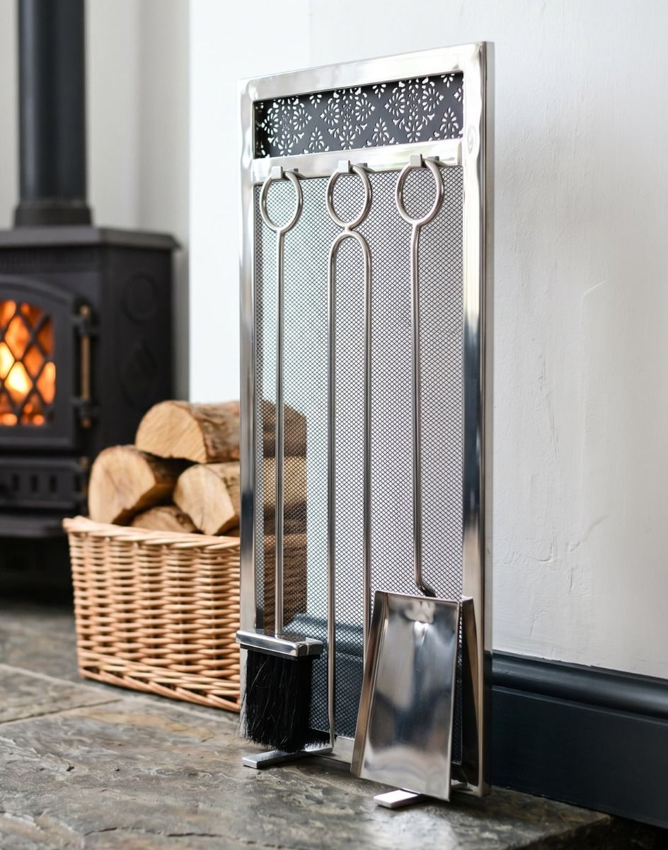 The 66cm “Highburn House” Stainless Steel Companion Set next to a Log Basket in a White Cottage Fireplace - Digital Illustration 