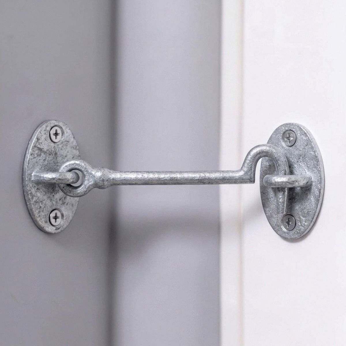 The 6 Inch "Masio" Galvanised Cabin Hook Shown From the Side Holding Open a Door - Digital Illustration