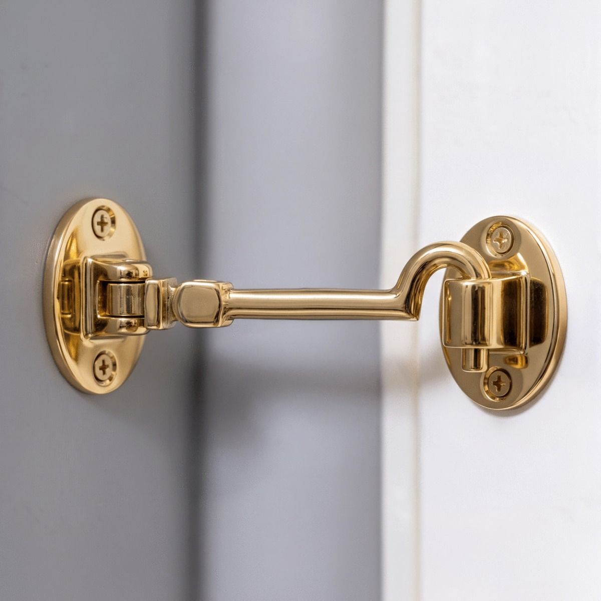 The 6 Inch Brass Cabin Hook Silent Type on a Grey Internal Wall Holding Open a White Door - Digital Illustration 