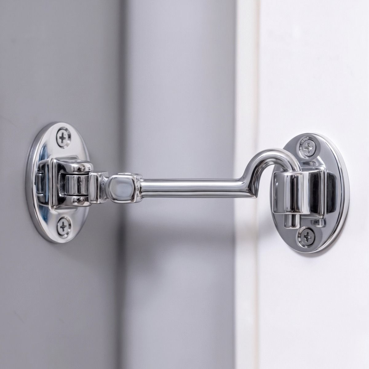 The 6 Inch Bright Chrome Cabin Hooks Silent Type Mounted on a Grey Wall to Prop Open a Door - Digital Illustration 