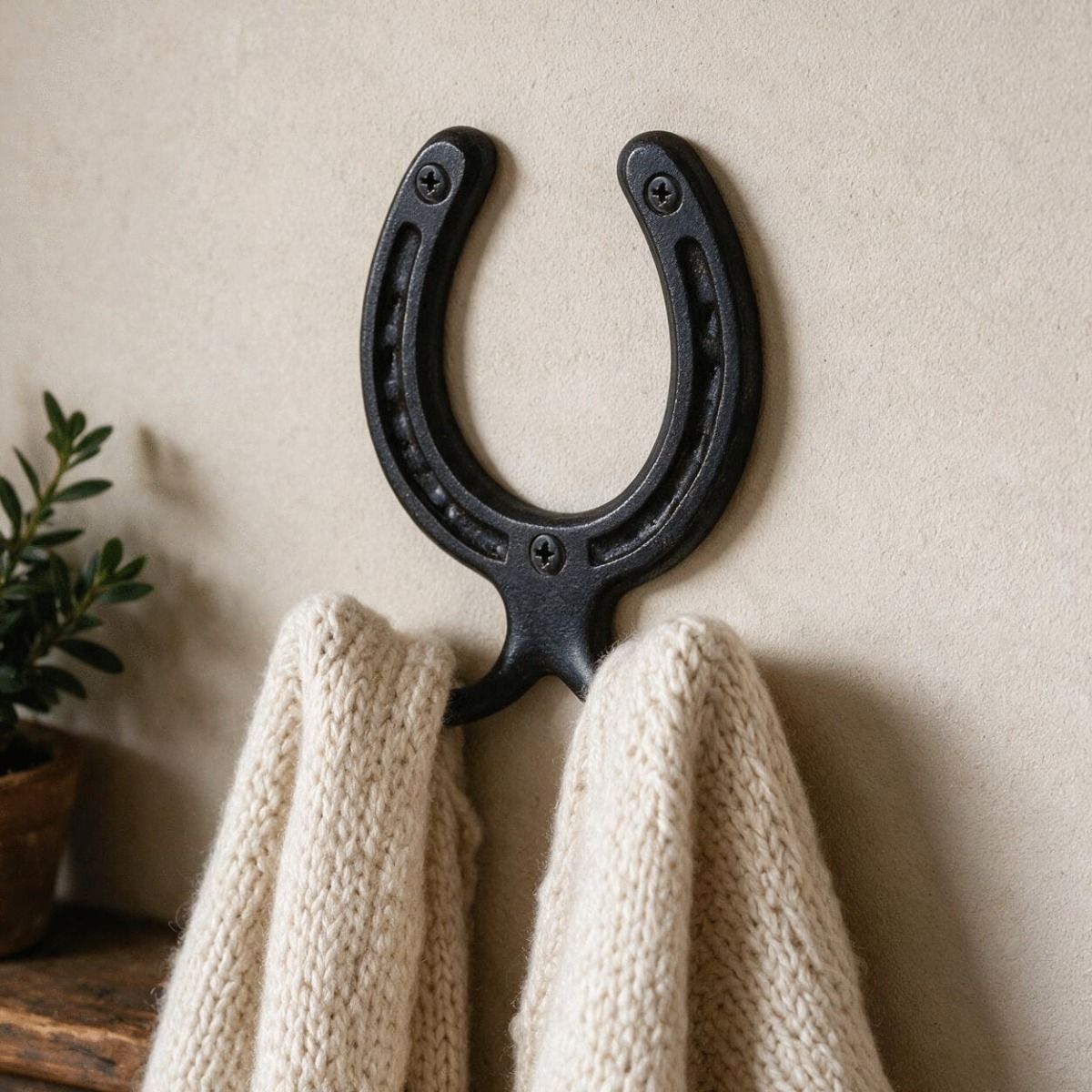 The 75mm Iron Horse Shoe Hook Mounted on a Wall in a Cosy Home Hallway - Digital Illustration 
