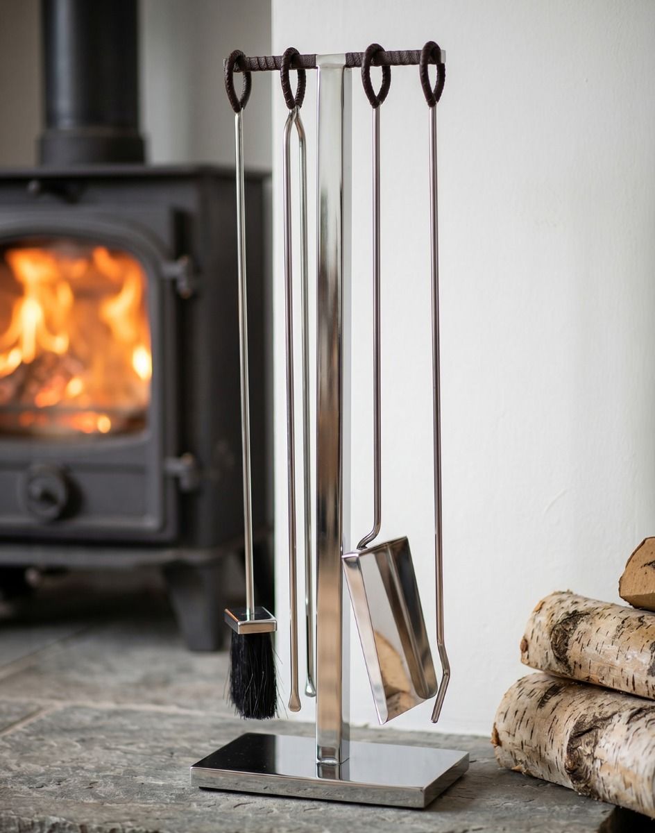 The 76cm “Baxter Loft” Stainless Steel and Leather Companion Set on a Stone Hearth next to a Log Burner Stove - Digital Illustration 