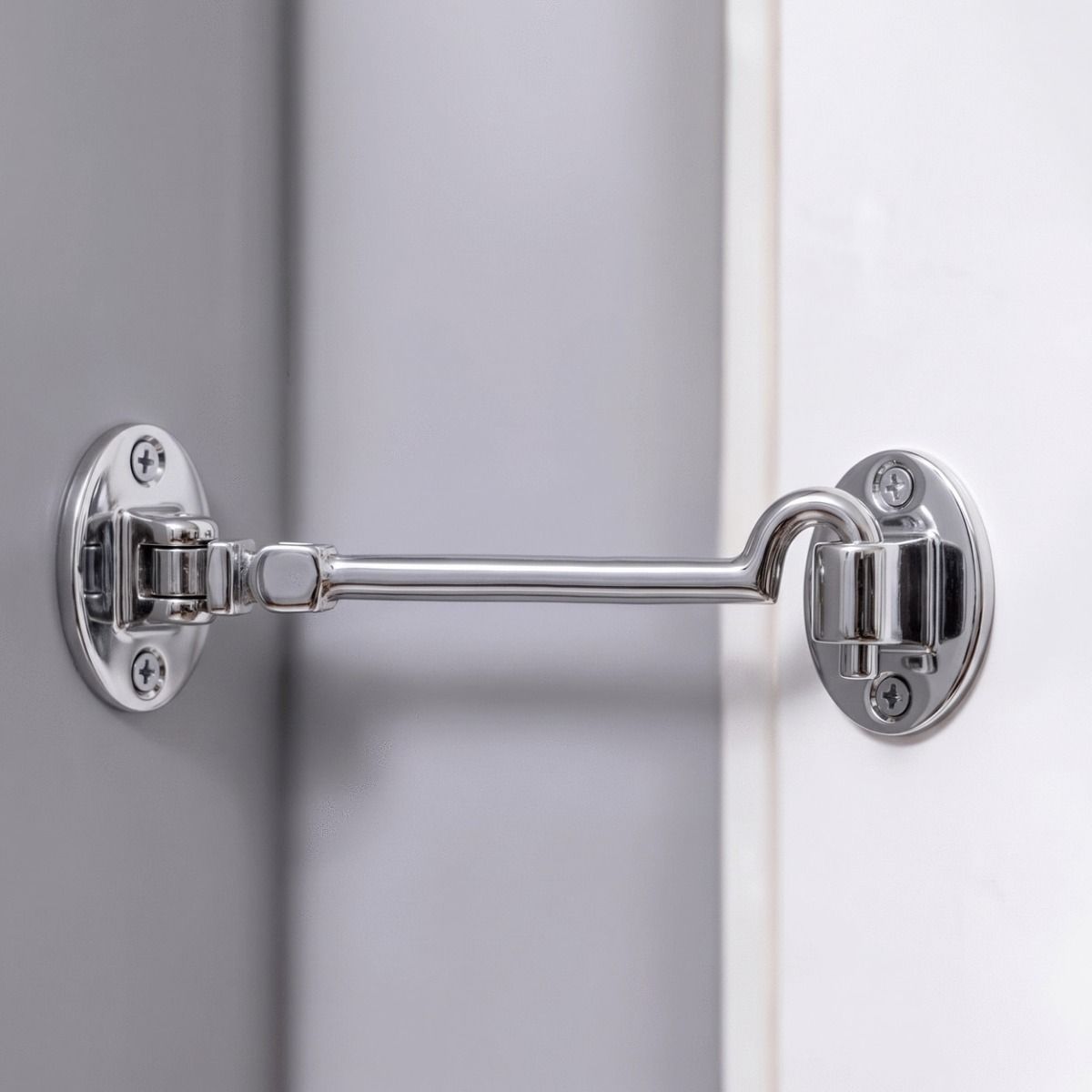The 8 Inch Bright Chrome Cabin Hooks Silent Type Heavy on a White Door in a Modern Home Interior - Digital Illustration 