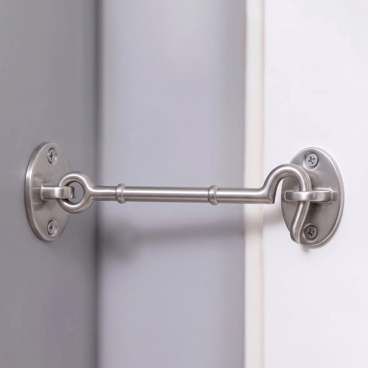 The 8 Inch Satin Chrome Cabin Hook Loose Ring Type Holding open a White Door in a Modern Home - Digital Illustration