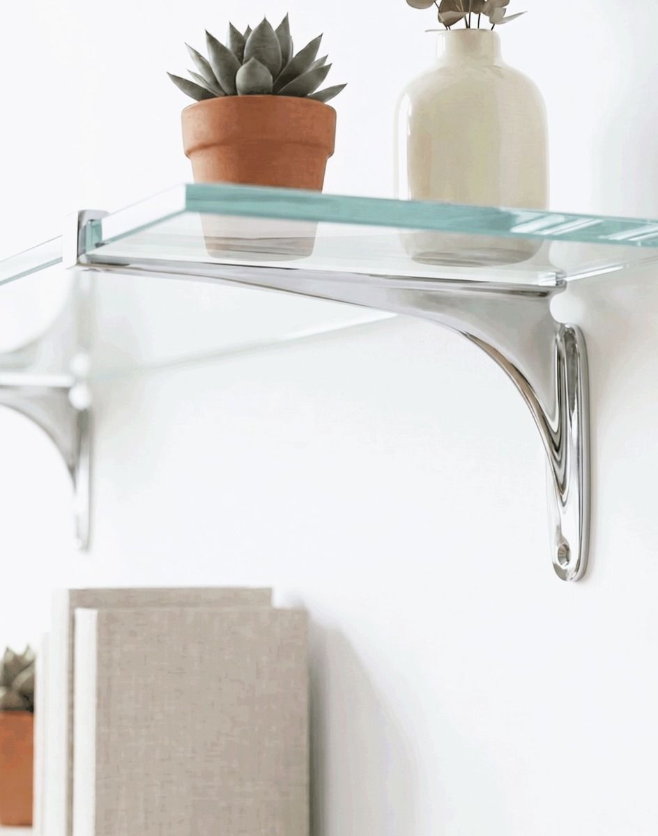 The 9cm x 18cm Kelsall" Bright Chrome Glass Shelf Bracket Mounted on a White Wall in a Modern Living Room - Digital Illustration