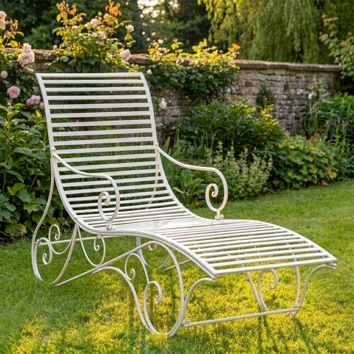 The "Windsor" Scrollwork Wrought Iron Sun Lounger in a Cream Finish Positioned on a Sunny Garden Lawn - Digital Illustration 