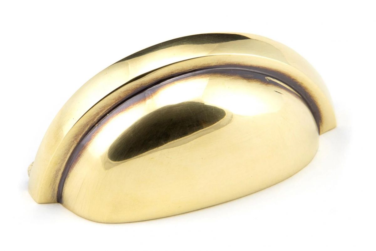 The Aged Brass Finish Cup Pull Handle on a White Background