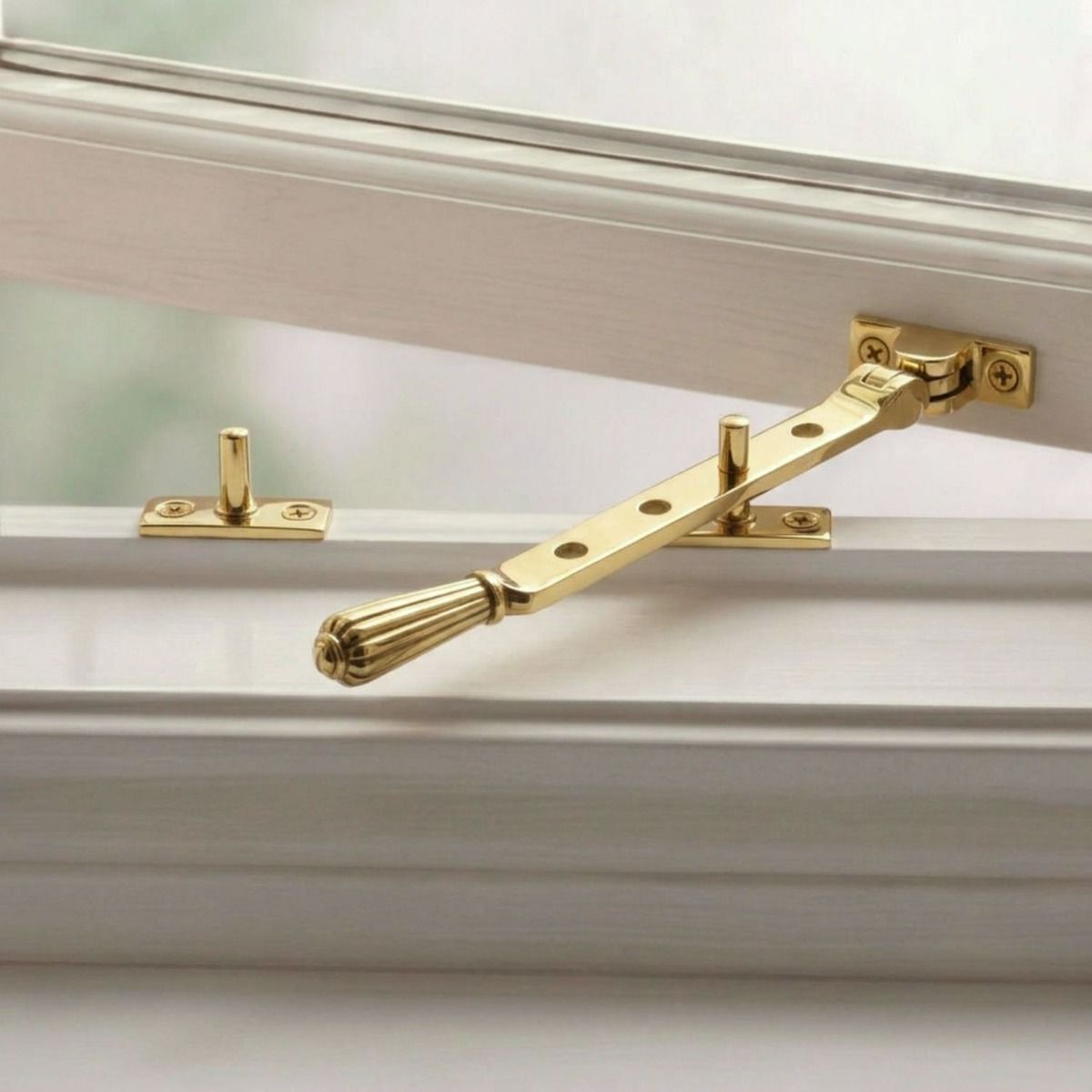 The Aged Brass Georgian Reeded Casement Window Stay on a White Window Frame - Digital Illustration