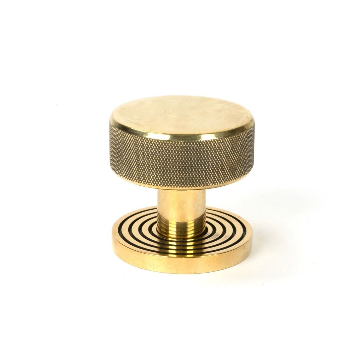 The Aged Brass Knurled Mortice/Rim Knob Set on a Beehive Rose Shown Upright on a White Background 