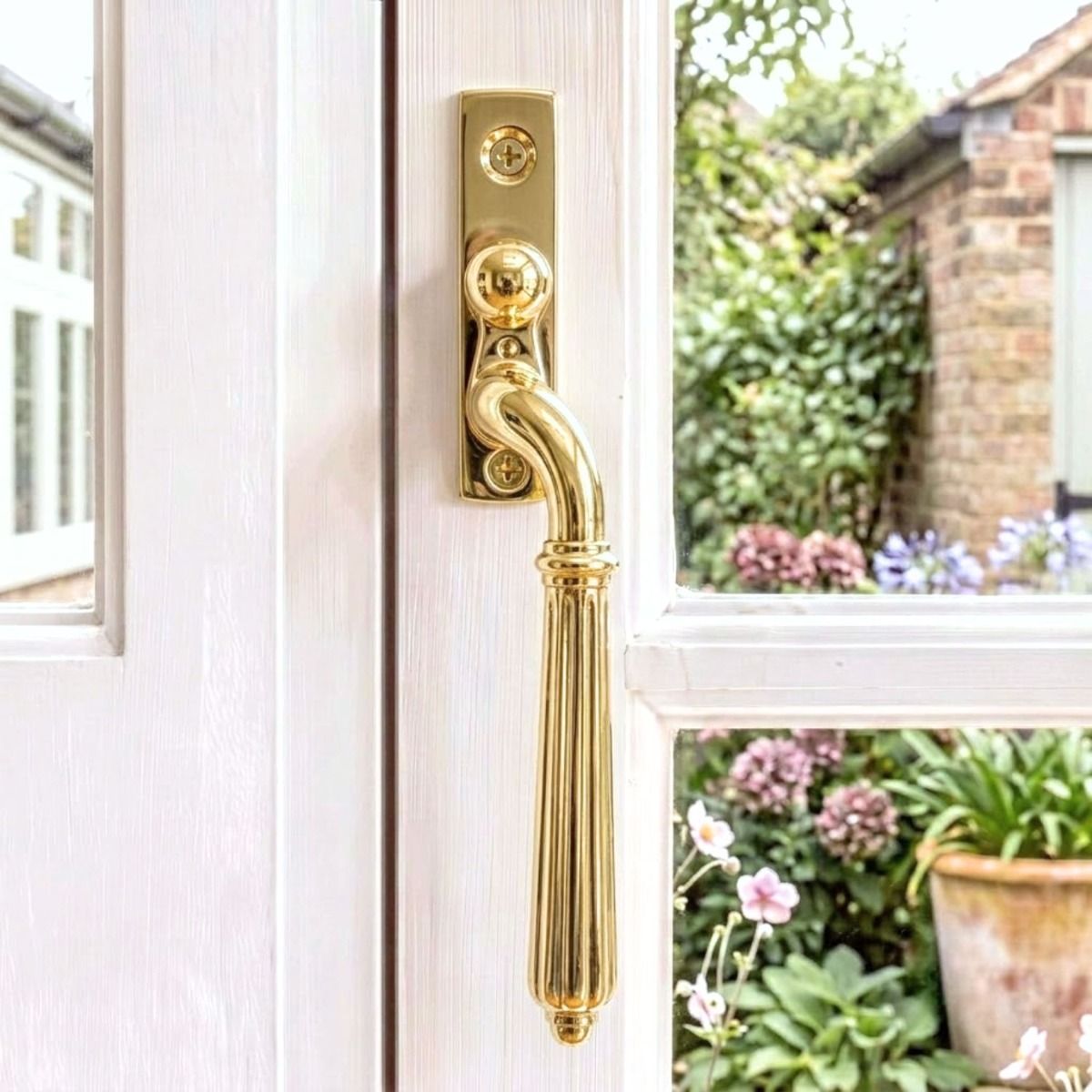 The Aged Brass Reeded Georgian Espagnolette Window Handle - Right-Handed on a Wooden Window Frame - Digital Illustration 