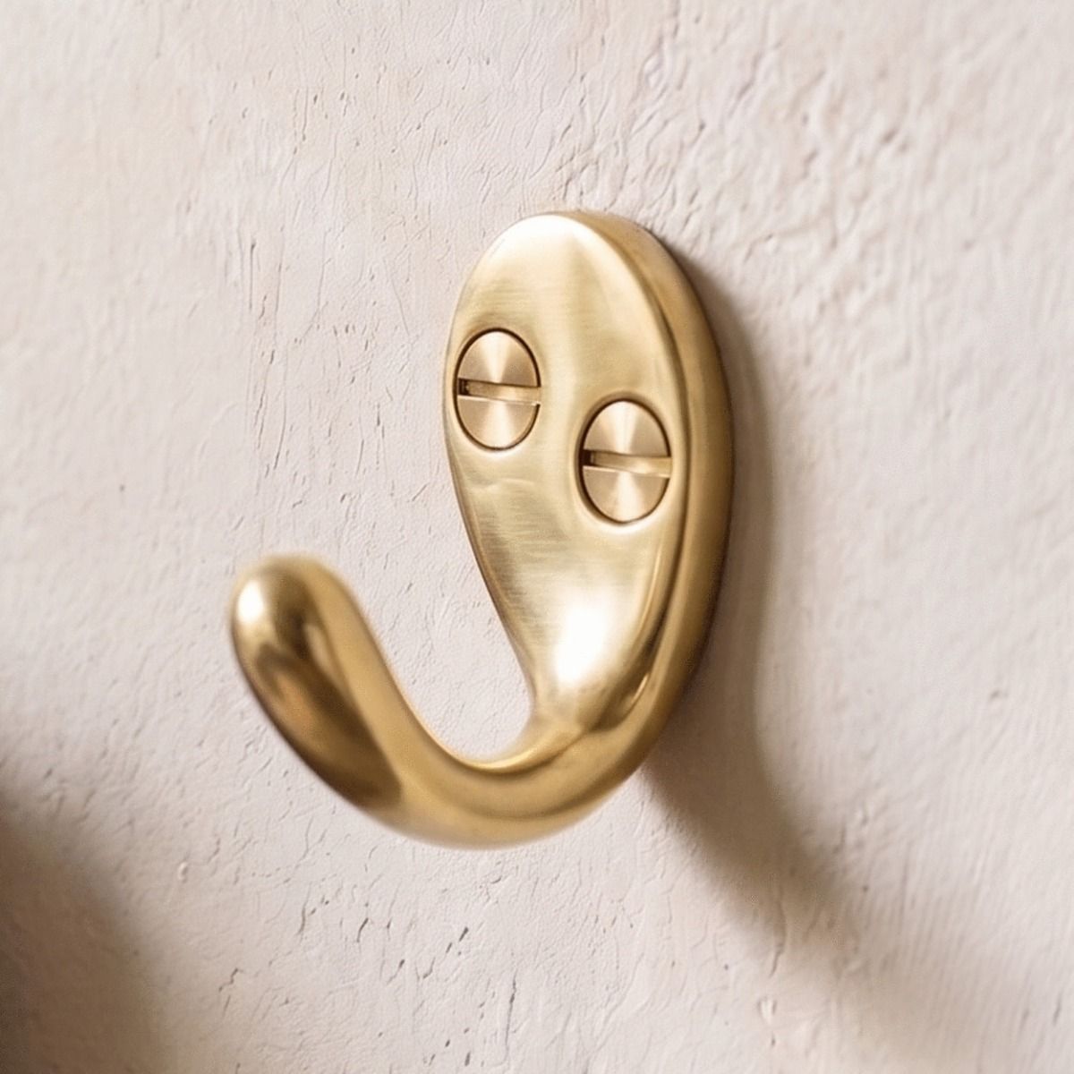 The Aged Brass Single Pronged Coat Hook on a Plaster Wall in a Home - Digital Illustration 