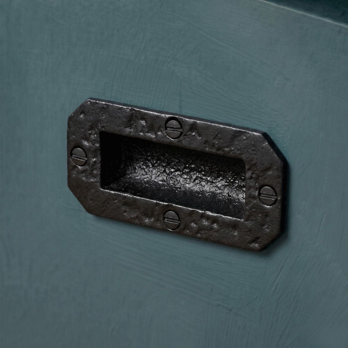 The Antique Black Iron Flush Fitting Drawer Pull Handle on a Sleek Blue Kitchen Drawer in a Modern Home - Digital Illustration