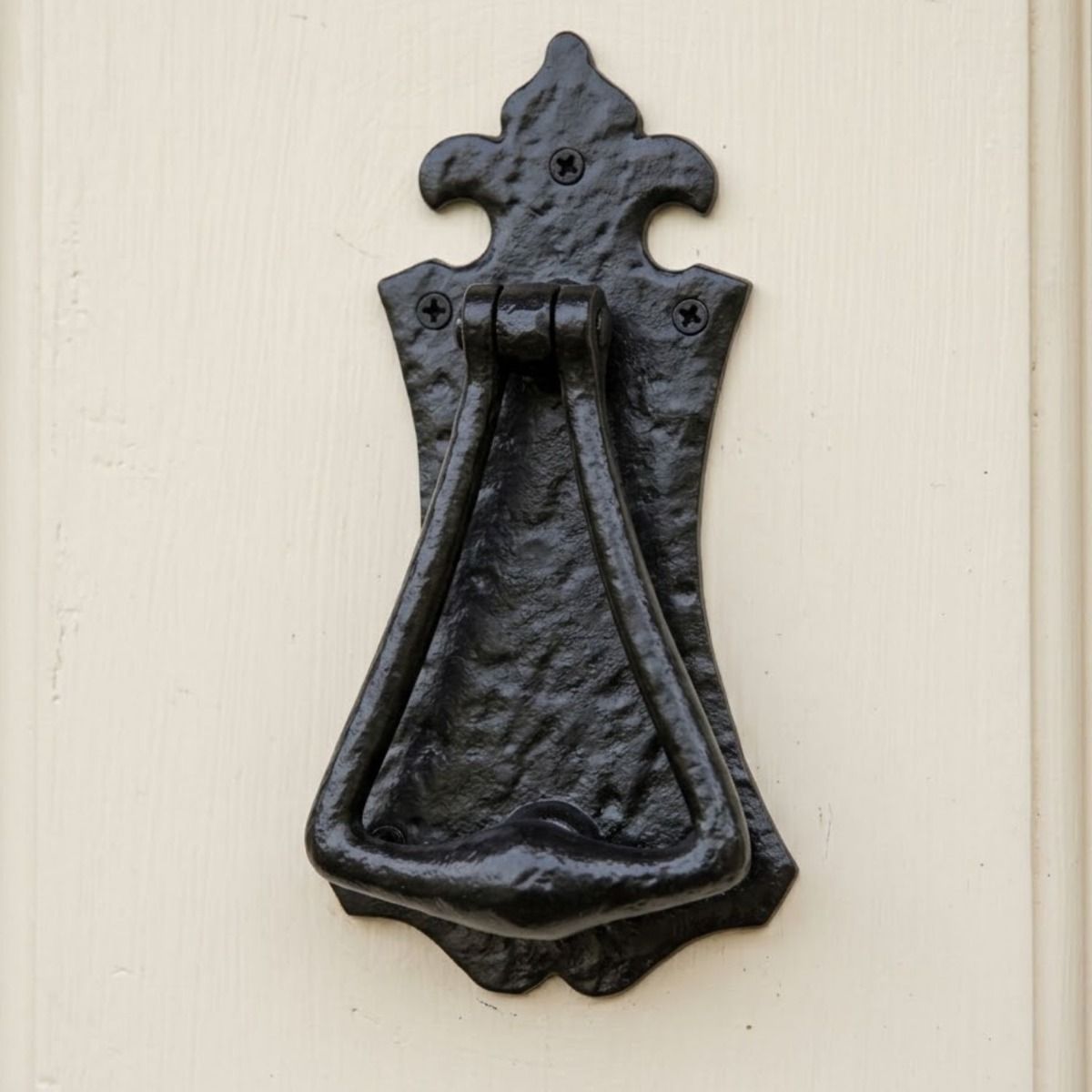 The Antique Black Iron Gothic Style Fleur De Lys Door Knocker on a Cream Coloured Front Door to a Country Cottage - Digital Illustration