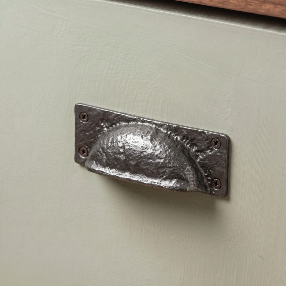 The Antique Black Iron Hooded Cabinet Or Drawer Pull Handle Fitted on a Wooden Kitchen Drawer in a Traditional Cottage - Digital Illustration