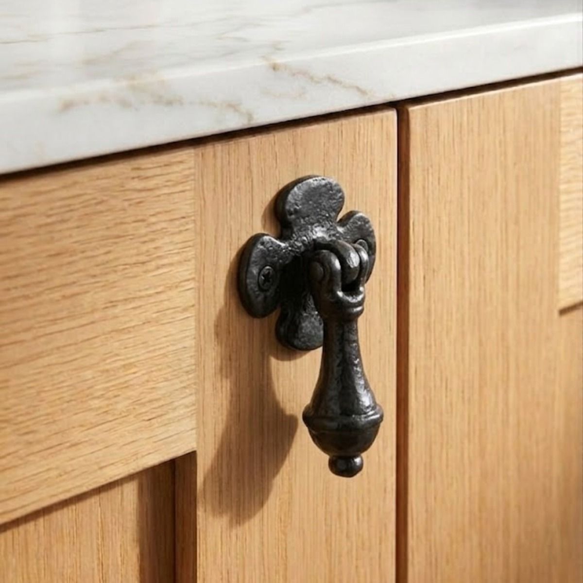 The Antique Black Iron Teardrop Cabinet Handle With Floral Backplate Mounted on a Contemporary Wooden Kitchen Cabinet - Digital Illustration 