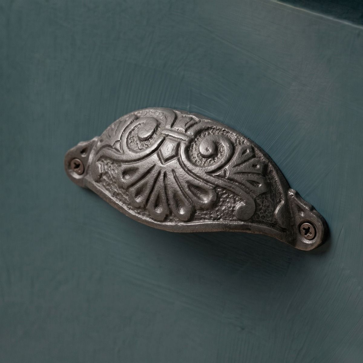 The Antique Petal Cabinet Pull Handles Shown Close up on a Blue Set of Drawers - Digital Illustration
