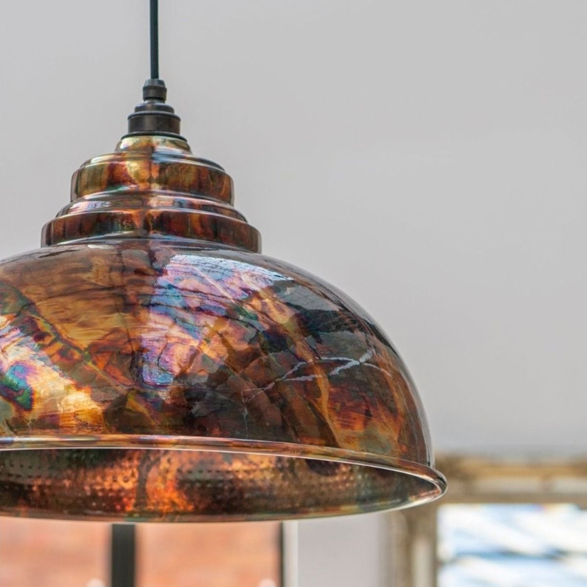 The Arcus Spun Pendant Light in Burnished Finish Shown Close Up in a modern Home 