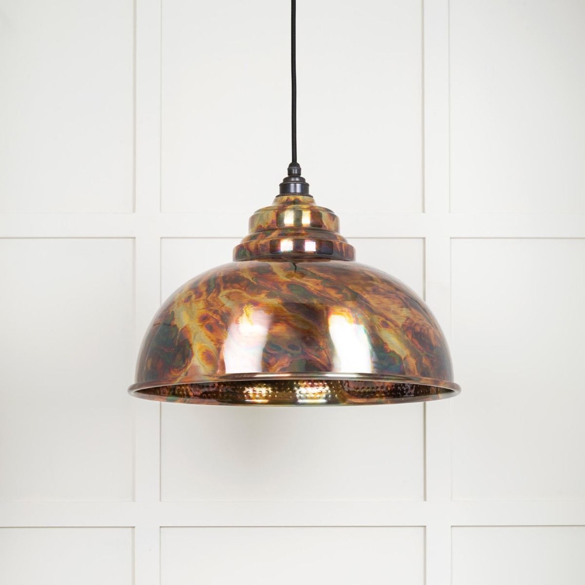 The Arcus Spun Pendant Light in Burnished Finish Shown on a White Panelled Background