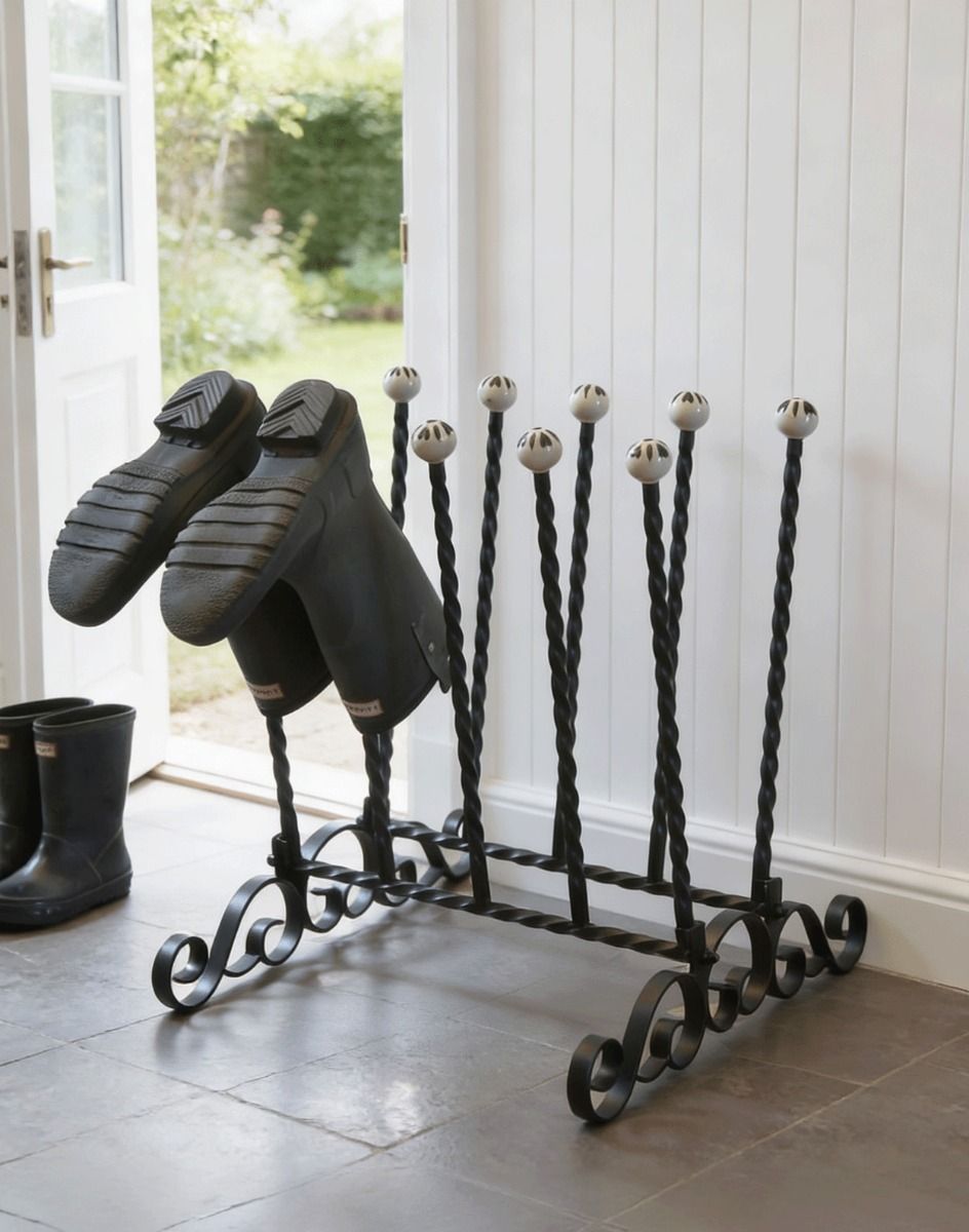 The Athleshaw Black 5 Pair Boot and Welly Rack on a Classic Stone Tiled Floor Next to a Kitchen Back Door - Digital Illustration 